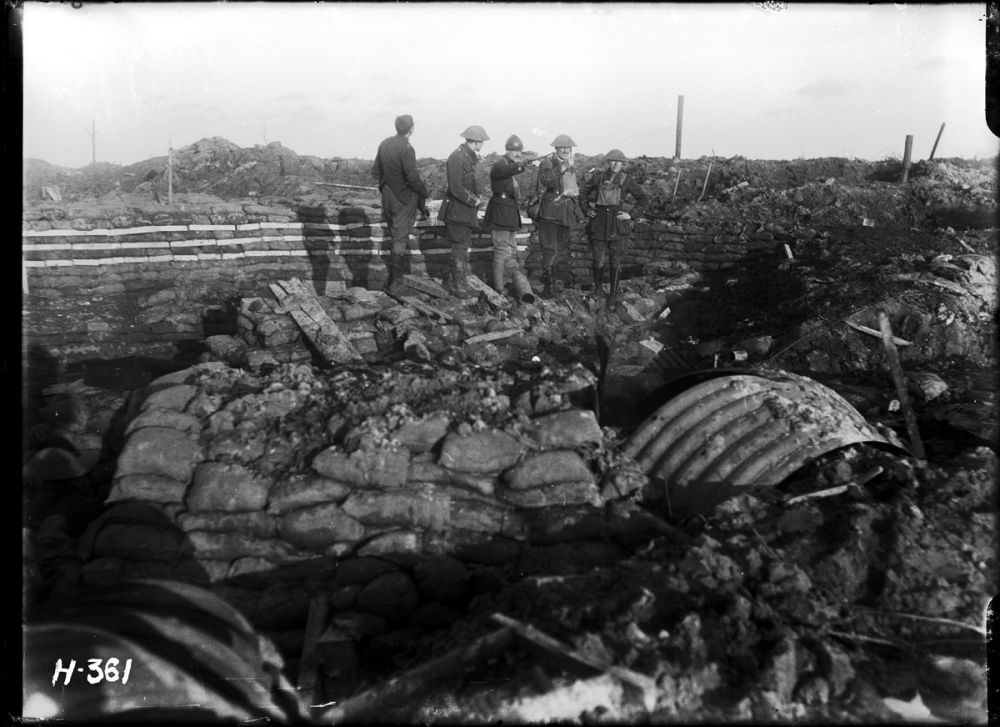 New Zealand officers watch a bombardment from a dugout at Hooge Crater.